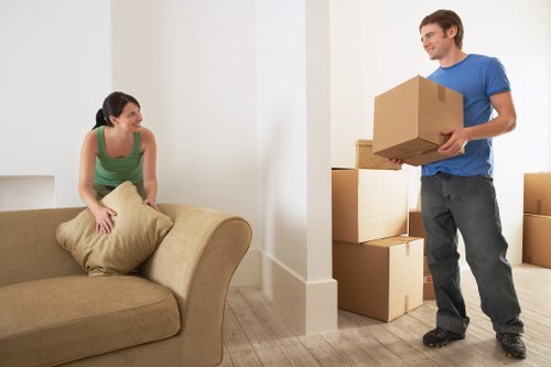 Professional movers handling apartment furniture during a flat move